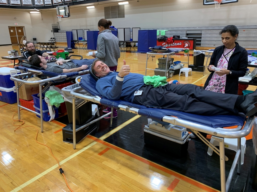 people laying on blood donation cots